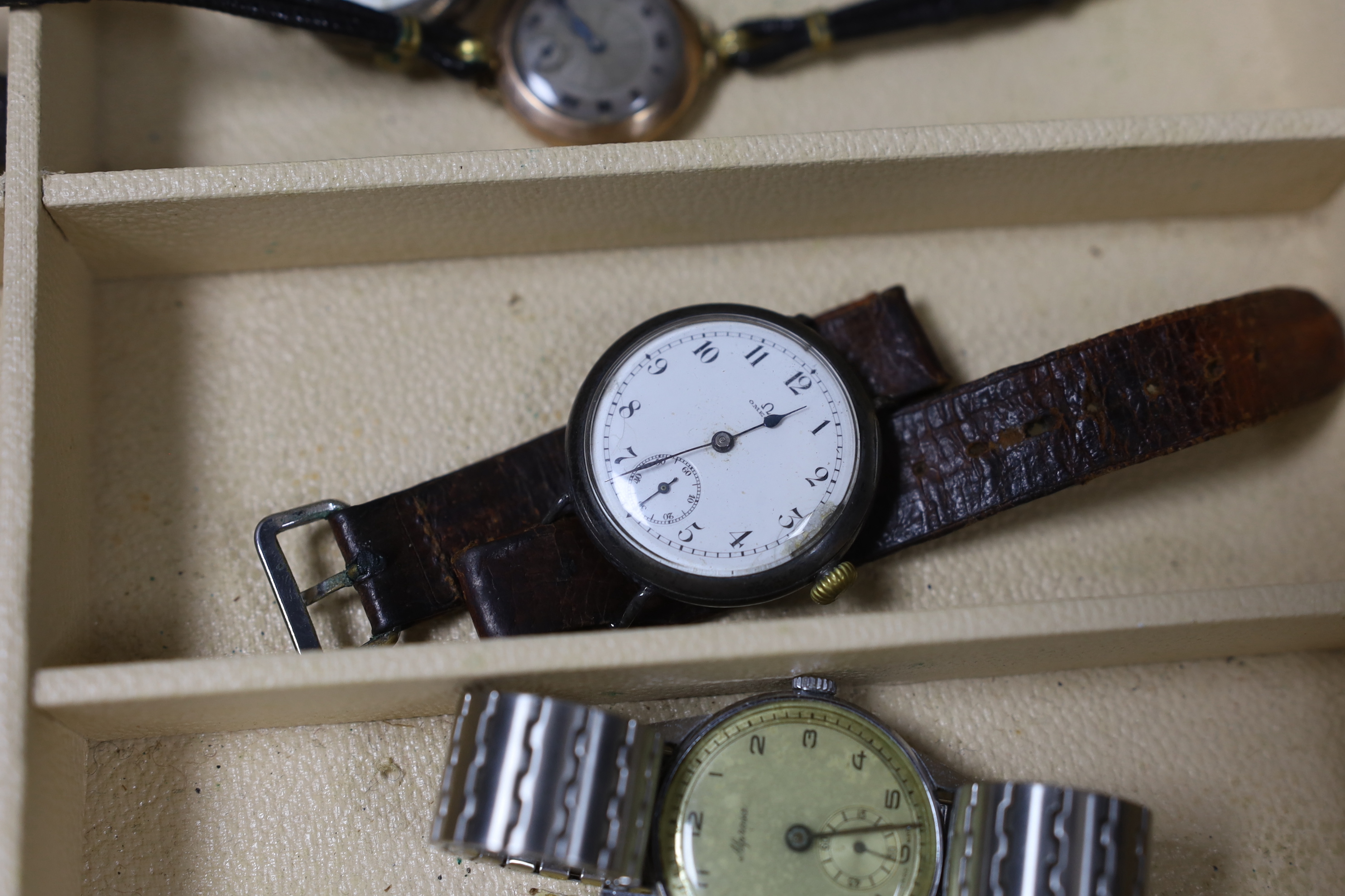 Seventeen assorted lady's or gentleman's wrist watches including a silver manual wind Omega, circa 1917 and a stainless steel Tudor, together with a pedometer?